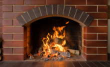 fireplace with clean brick and roaring fire